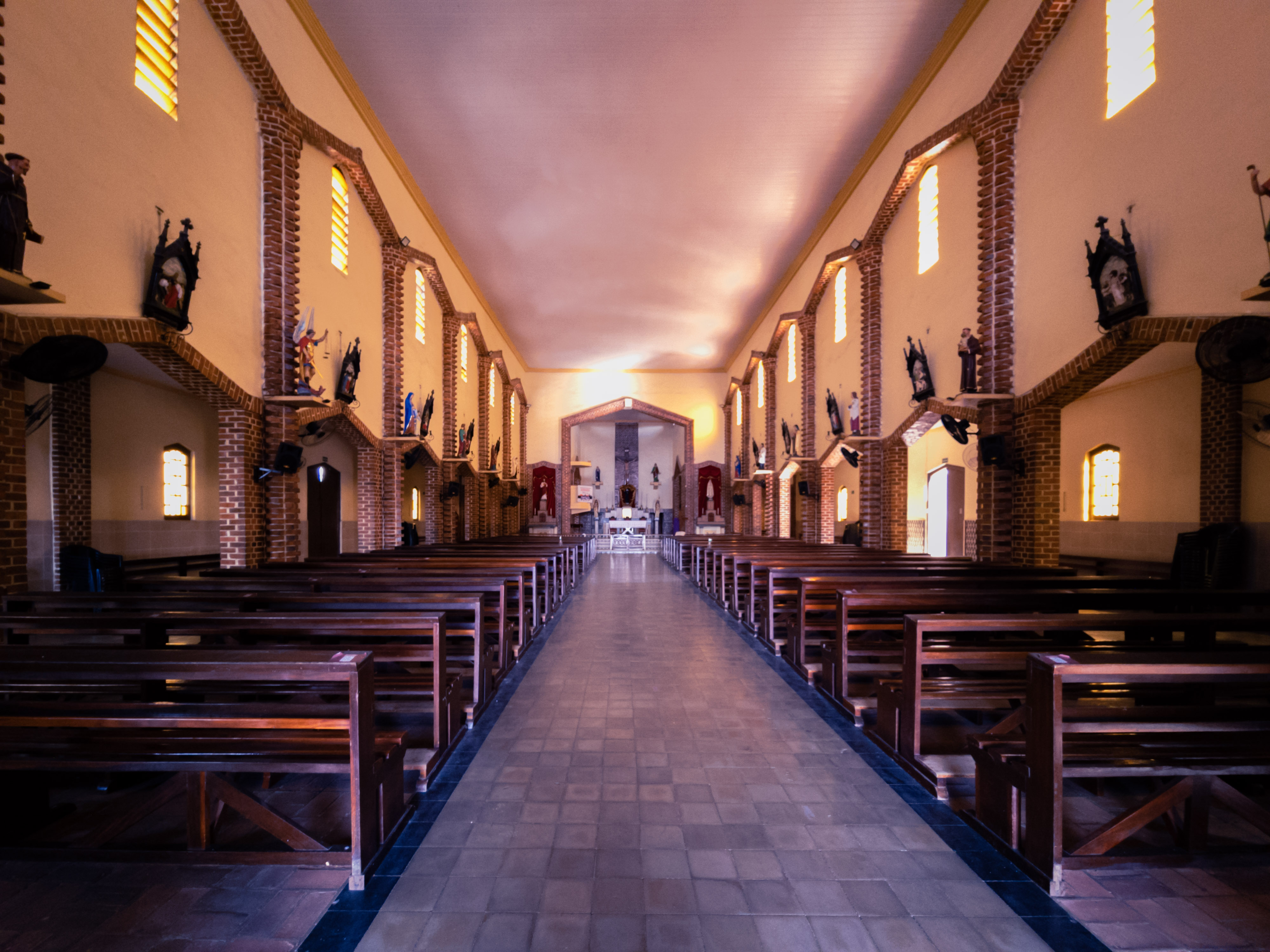 Wide view down the empty chapel nave toward the altar
