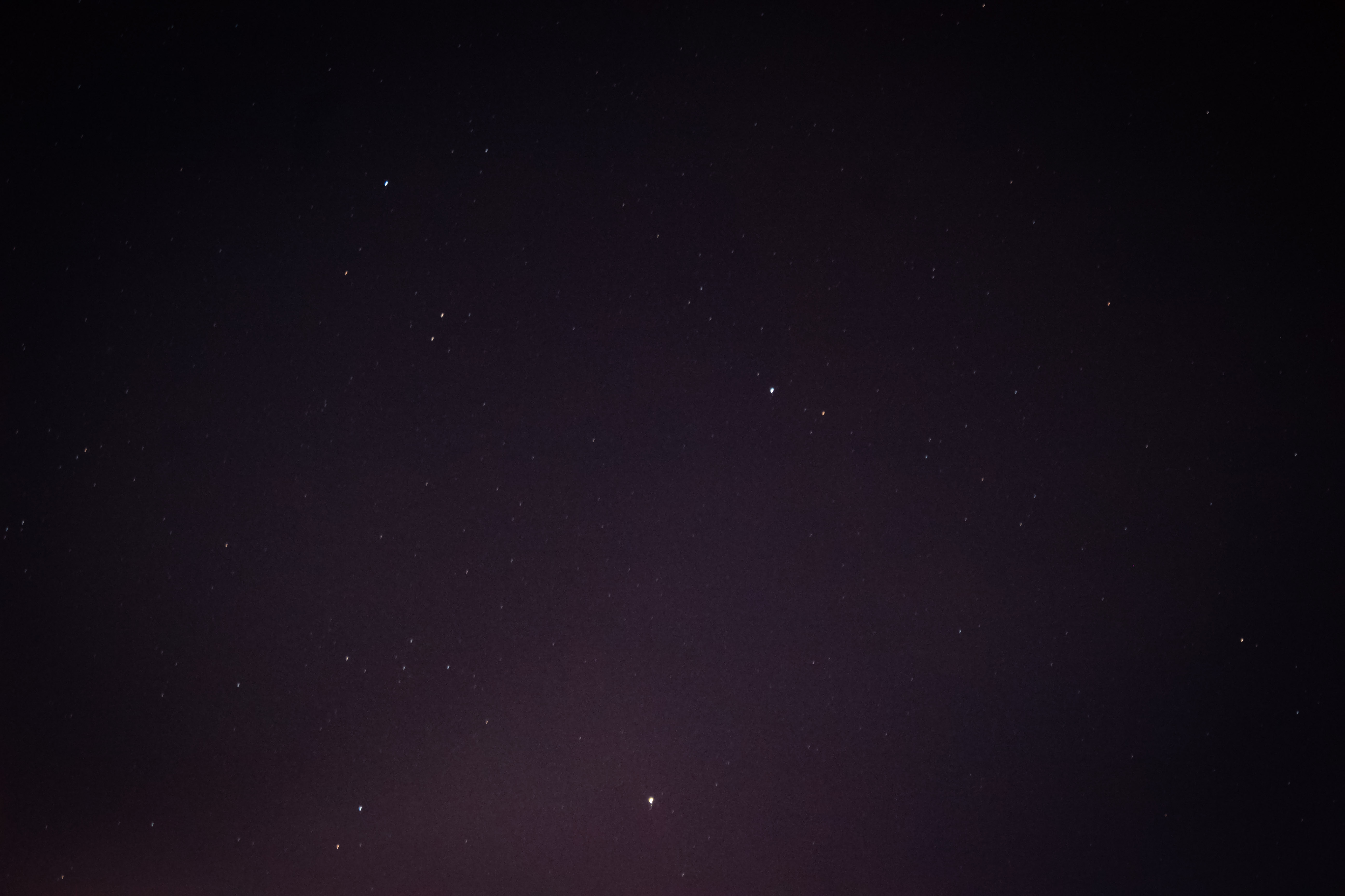Starry night sky with a glow from the city lights